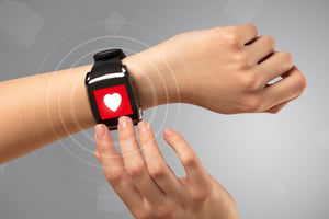 Female hand with smartwatch and with heart rate icon on the watch